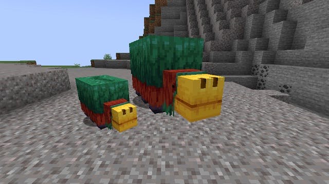 An adult Sniffle and a baby Snifflet in a Minecraft Mountain biome. 